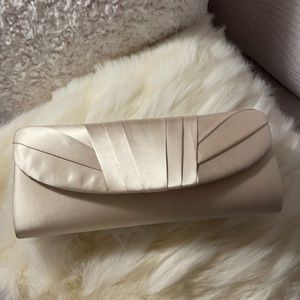 That feel of old Hollywood glamour “champagne” colored satin clutch with strap.